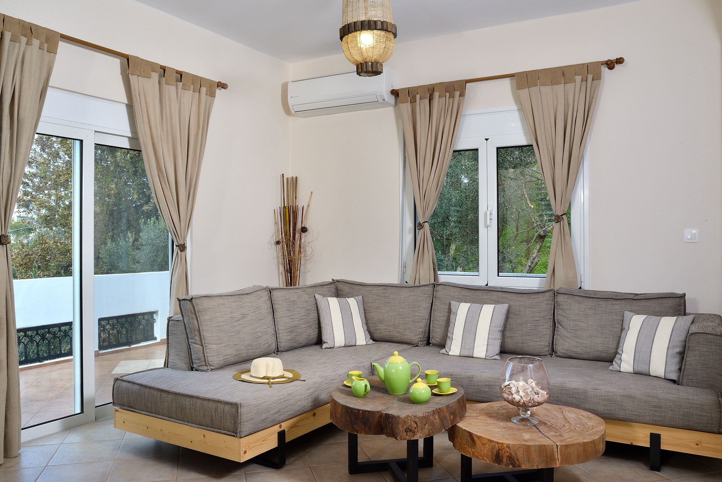A modern living room with a sectional sofa, a round coffee table, and a dining set.