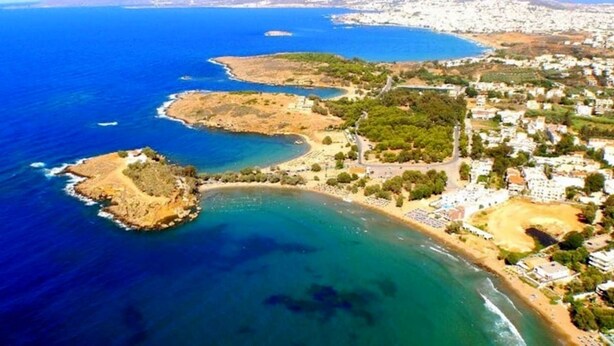 An aerial view of a coastal area with a beach, a small island, and a town with buildings and roads. - Villa ANVA, amazing views, walk to the beach (Daratsos)