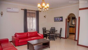 42-inch flat-screen TV with satellite channels, TV - Asunita Properties (Kampala)