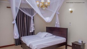 Premium bedding, Tempur-Pedic beds, laptop workspace, blackout drapes - Asunita Properties (Kampala)
