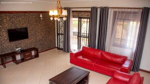 42-inch flat-screen TV with satellite channels, TV - Asunita Properties (Kampala)