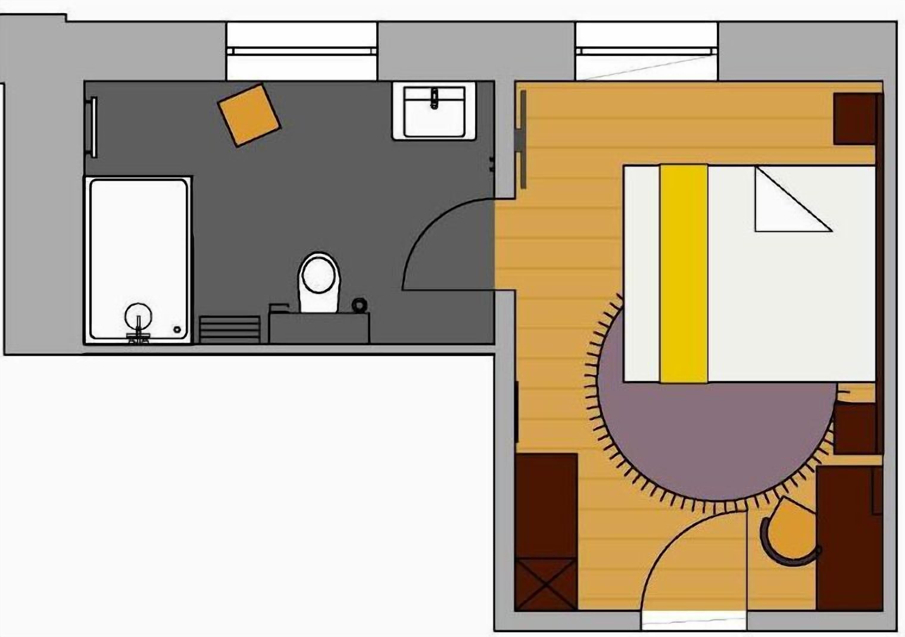 A hotel room layout with a bed, a small desk, a chair, a wardrobe, and a bathroom.