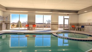 An indoor swimming pool with clear windows, a hot tub, and outdoor seating. - Hawthorn Extended Stay by Wyndham Loveland (Loveland)
