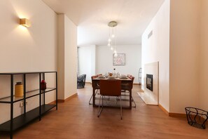 Enjoy meals in this stylish dining area with a rectangular table for four, accompanied by matching chairs.