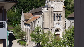 A church with a tall steeple and a clock tower.