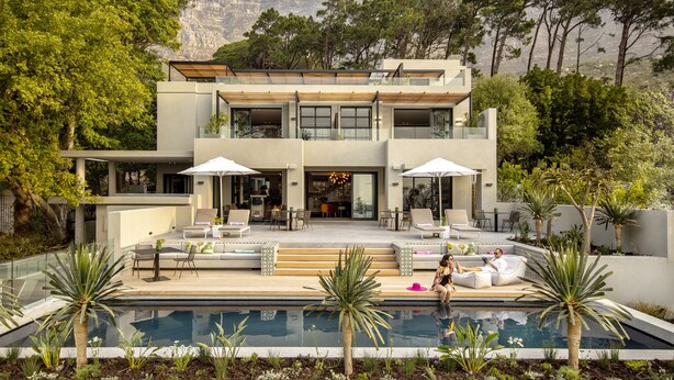 A modern two-story house with a swimming pool, outdoor seating, and a mountain backdrop. - Camissa House (Cape Town)