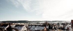 A town with multiple buildings, including houses and a church, under a clear sky.