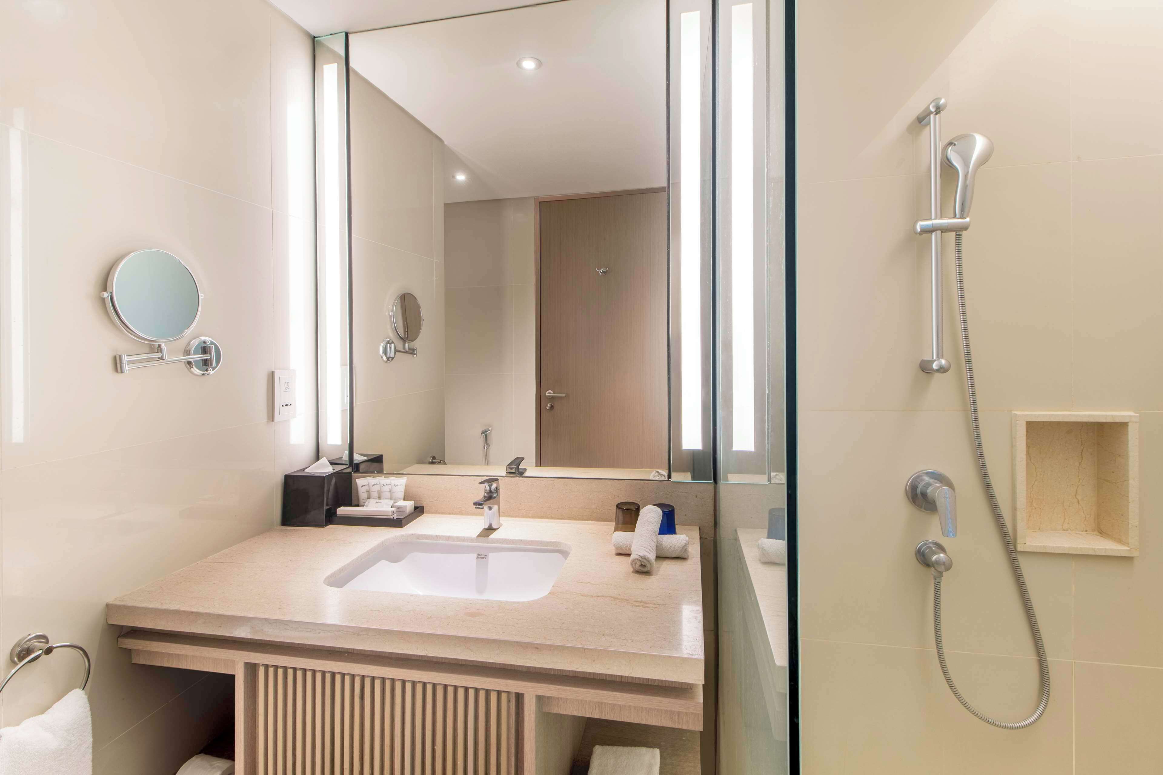 deluxe room | bathroom | eco-friendly toiletries, hair dryer, bidet, towels