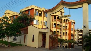 A hotel named "Sunset Paradise" with a distinctive architectural style, featuring multiple balconies and a large entrance gate. - Fastcare Luxury Apartments/Villas (Mtwapa)