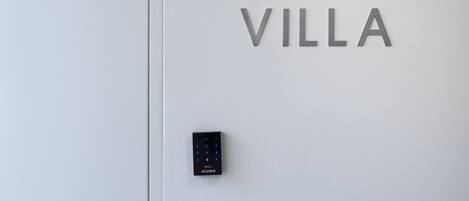 A door with the words "GARDEN VILLA" and a keypad lock.