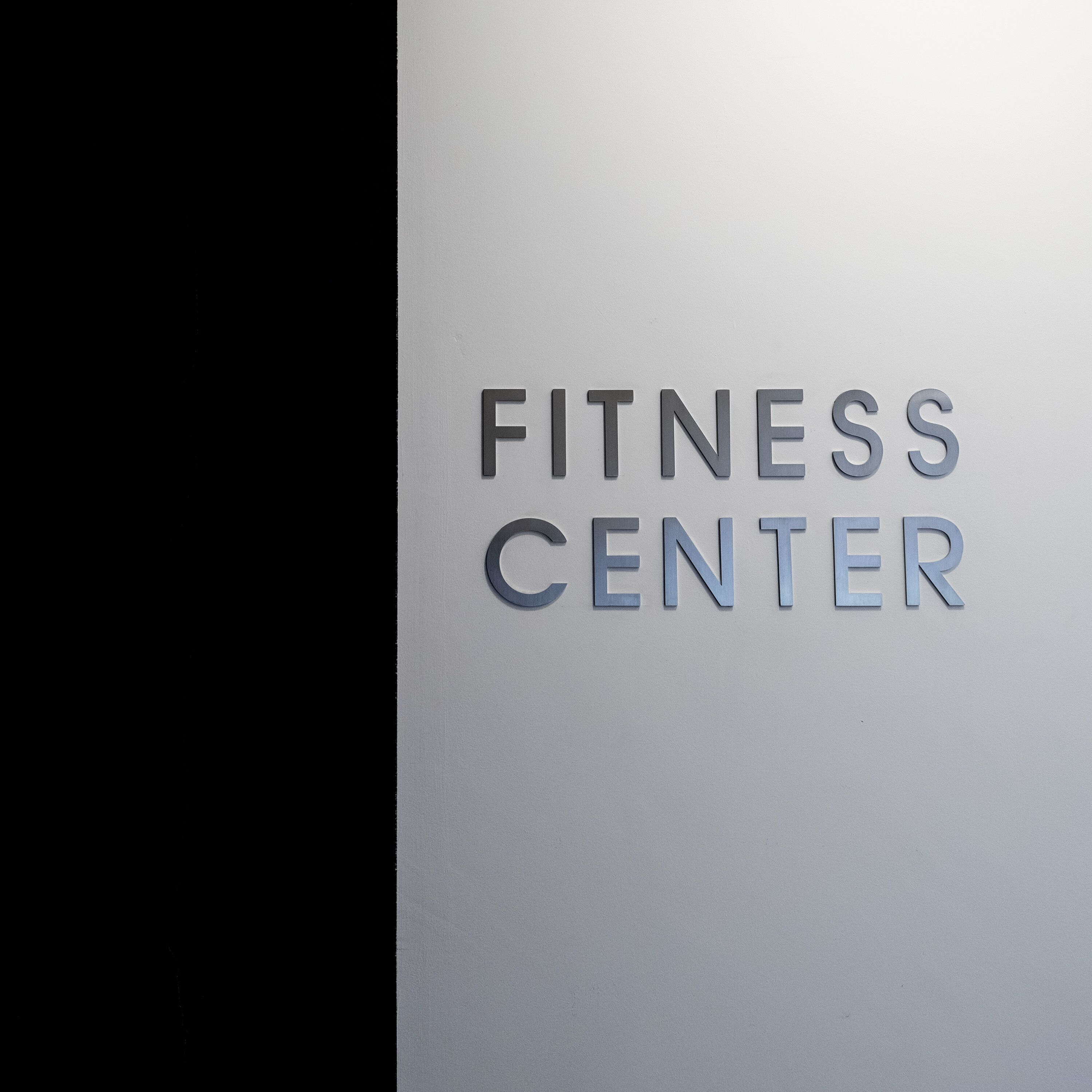 A sign with the words "FITNESS CENTER" in capital letters.