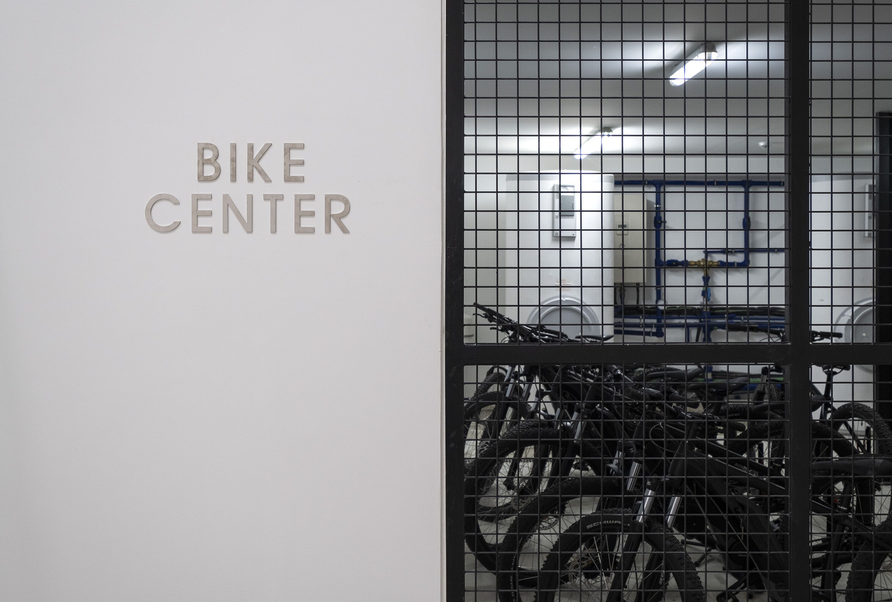 A bike center with a sign and a view of bicycles inside.