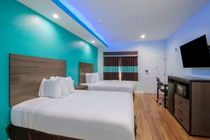A hotel room with two beds, a desk, a flat-screen TV, and a microwave. - Americas Best Value Inn Aldine Westfield (Humble)