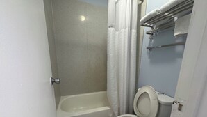 A bathroom with a bathtub, toilet, and shower curtain. - Days Inn by Wyndham Charlotte University (Charlotte)