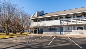 A two-story building with a parking lot in front. - Days Inn by Wyndham Charlotte University (Charlotte)