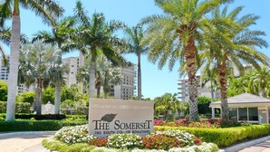 A sign for The Somerset at 780 South Collier Boulevard, surrounded by well-maintained landscaping and palm trees. - Beachfront Condo With Huge Views/pools/tennis/grills (Marco Island)