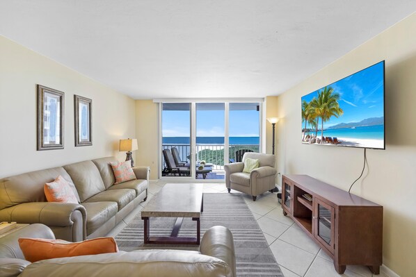 Condo, Multiple Beds (Stylish beachfront condo with pool an) | Living area | Flat-screen TV