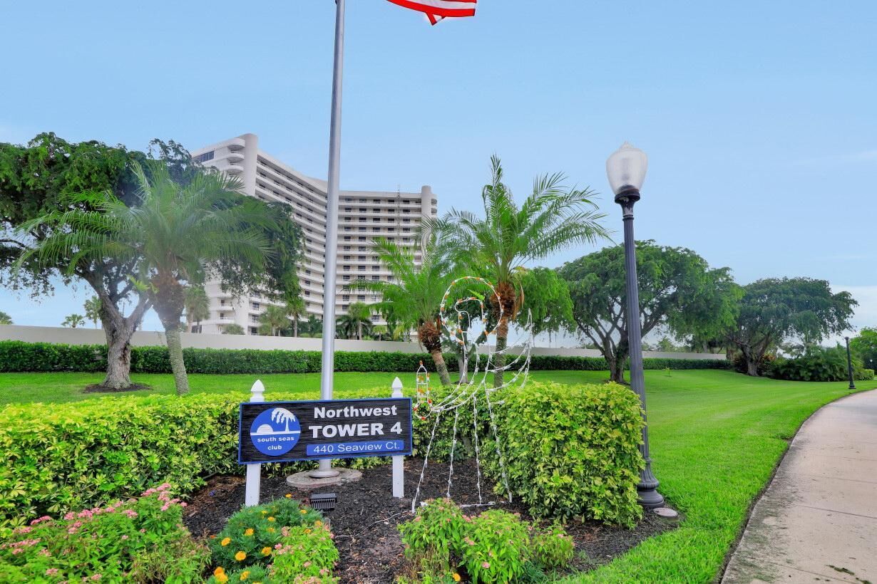 A sign for Northwest Tower 4, a hotel with a view of a building in the background.