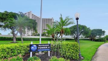 A sign for Northwest Tower 4, a hotel with a view of a building in the background.
