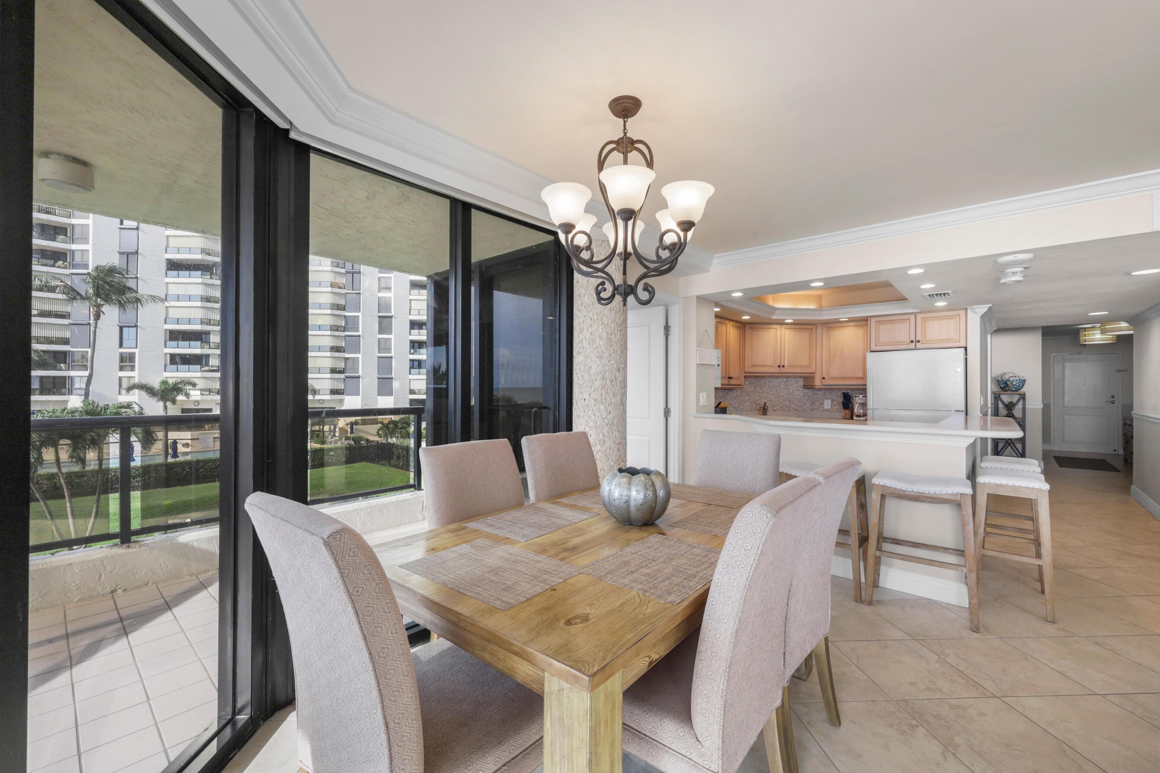 A modern dining area with a wooden table, cushioned chairs, and a decorative centerpiece.