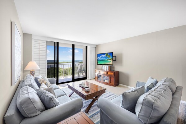 Condo, 1 King Bed with Sofa bed (Alluring beachfront condo with pool a) | Living area | Flat-screen TV