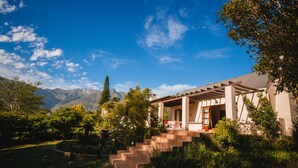 A modern house with a covered porch, a stone staircase, and a sign reading "Berry Cottage." - Wildebraam Berry Estate (Swellendam)