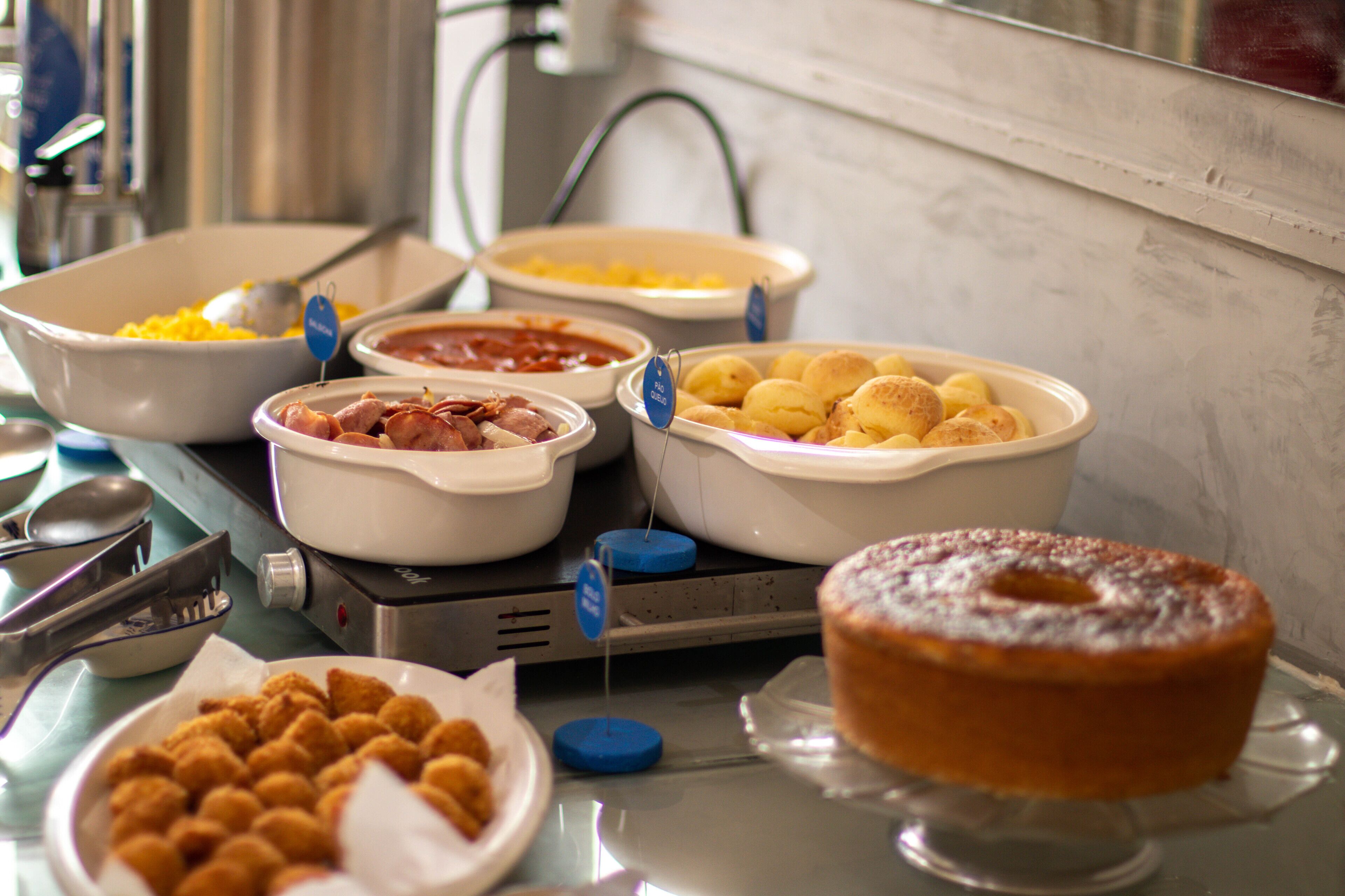 A buffet table with various food items including a cake and several dishes.