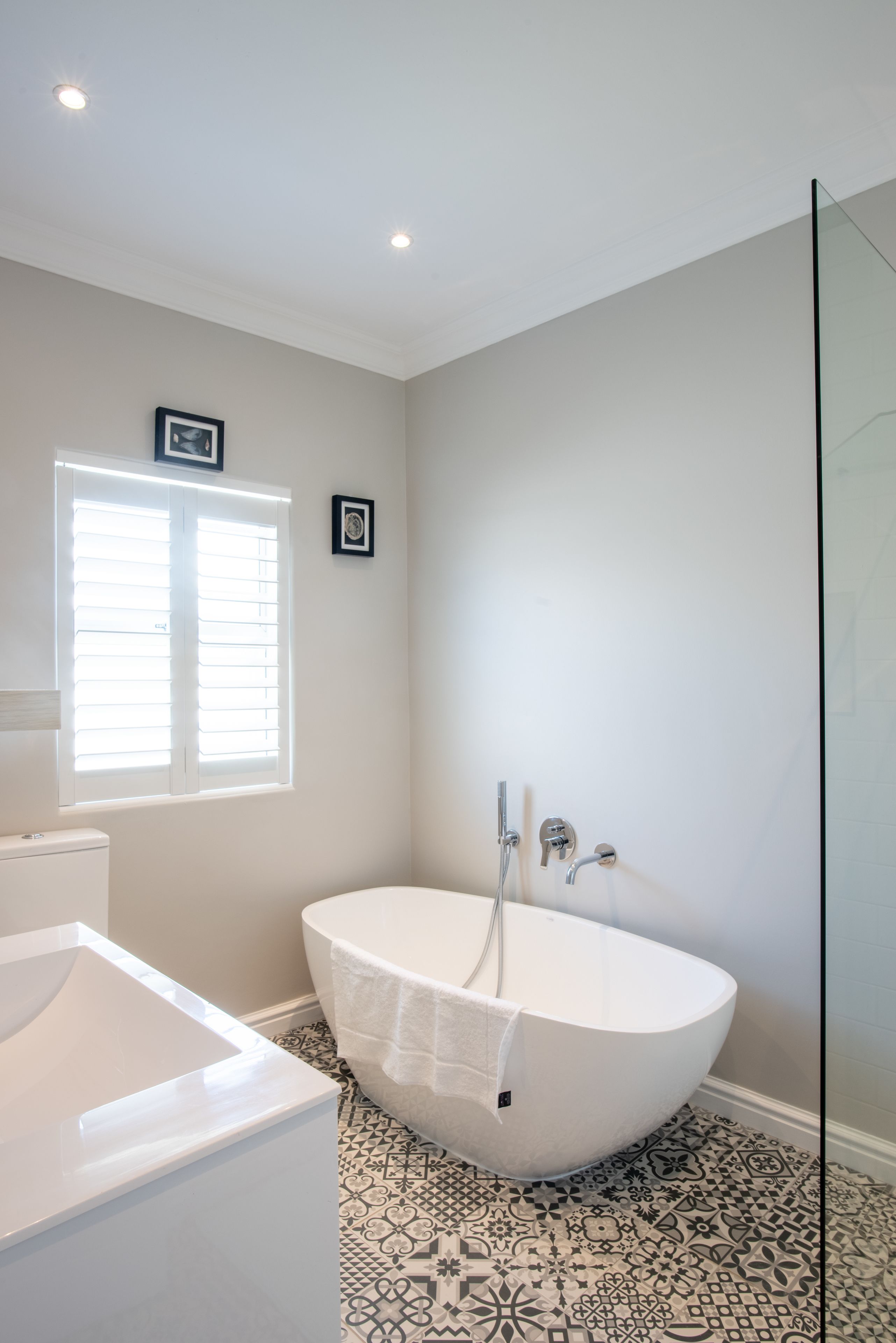 A bathroom with a freestanding bathtub, a toilet, and a shower area.