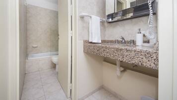 A bathroom with a toilet, sink, and bathtub.