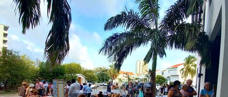 An outdoor market with various stalls and people.