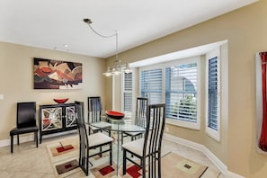 Enjoy meals in this stylish dining area with a glass-top table and comfortable seating for four.