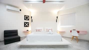 A modern bedroom with a large bed, bedside tables, a ceiling fan, and a window.