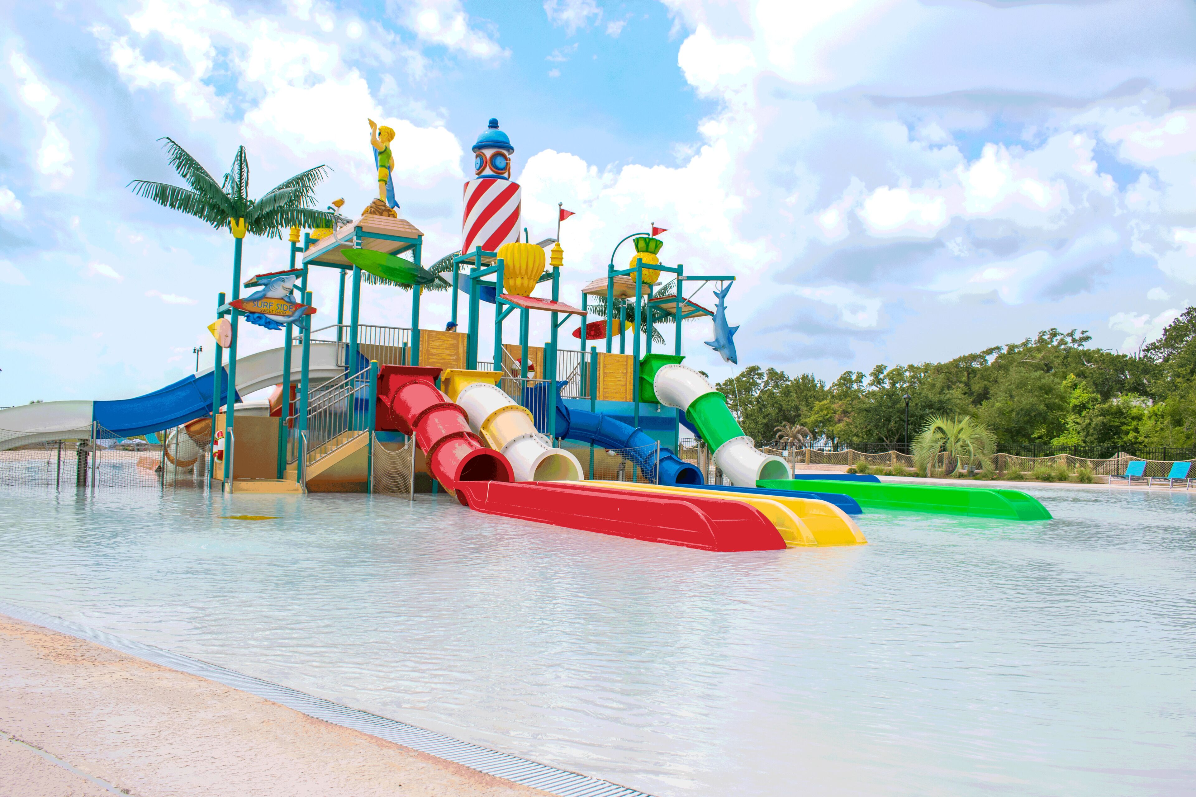 A water park with multiple slides and a large, colorful play structure.