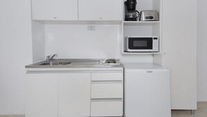A compact kitchenette with a built-in microwave, coffee maker, and a small refrigerator. - Velez Sarsfield Apartment AJC (Córdoba)