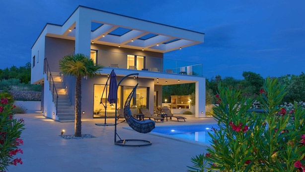 A modern two-story house with a swimming pool, outdoor seating, and a hammock. - Villa QUADRA with heated pool (Pinezići)