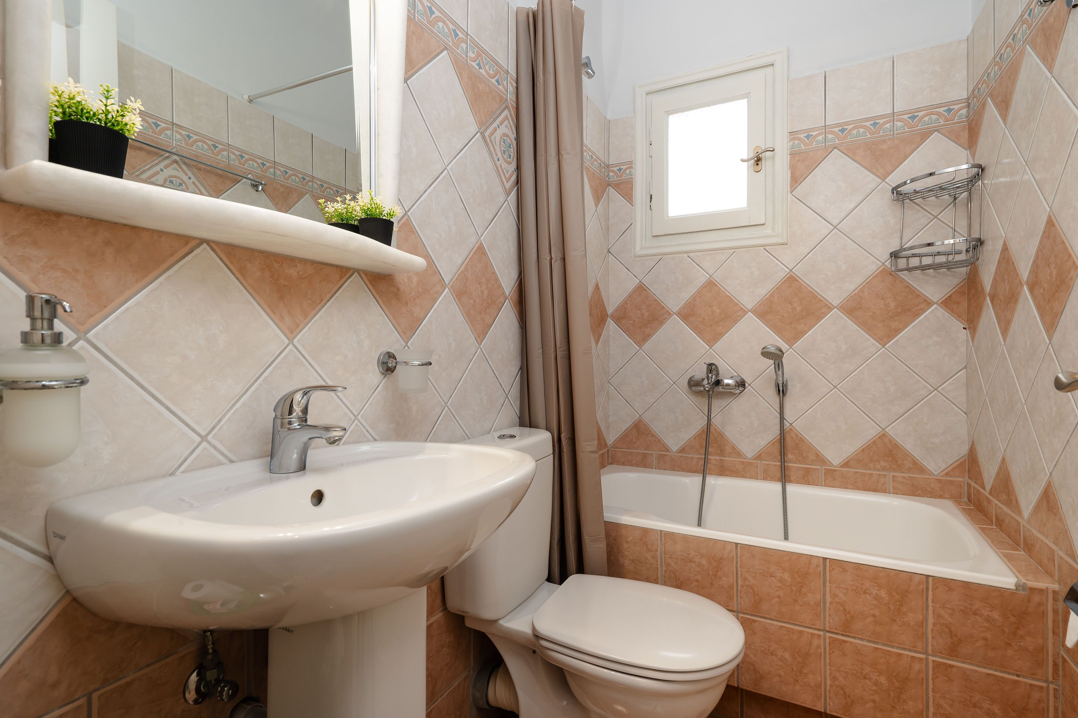 A bathroom with a sink, toilet, and bathtub.