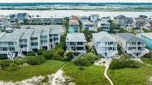 A coastal residential area with beachfront properties featuring balconies and multiple stories. - Oceanfront Townhome with Amazing Ocean Views (Wrightsville Beach)