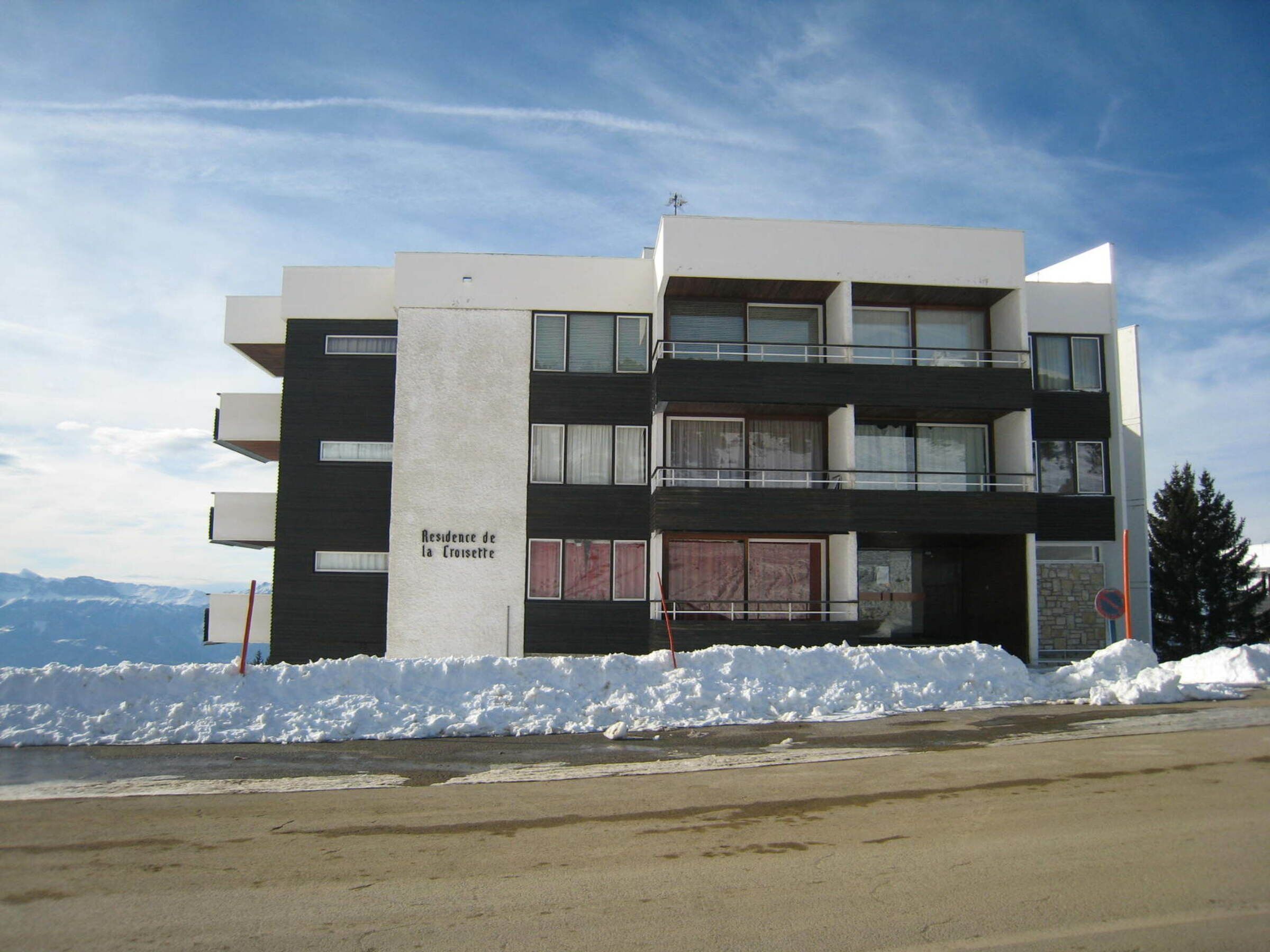 A modern multi-story building with a flat roof, large windows, and a sign reading "Residence de la Croisette".