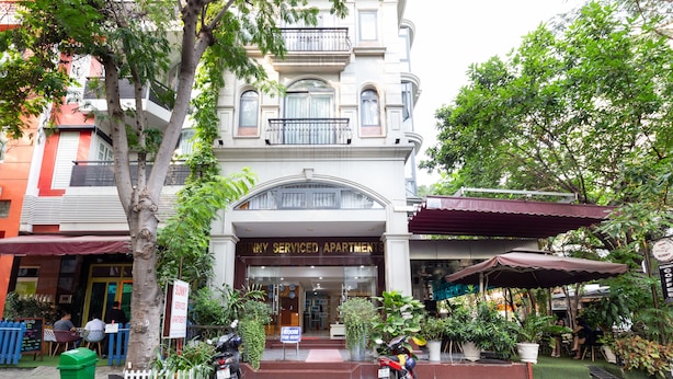 A multi-story building with a sign reading "Sunny Serviced Apartments." - Sunny Hotel and Apartment (Ho Chi Minh City)