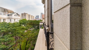 A balcony with a view of a cityscape, including tall buildings and greenery. - Sunny Hotel and Apartment (Ho Chi Minh City)