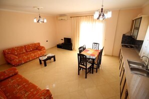 Deluxe Apartment, Multiple Beds, Sea View | Living area | Fireplace