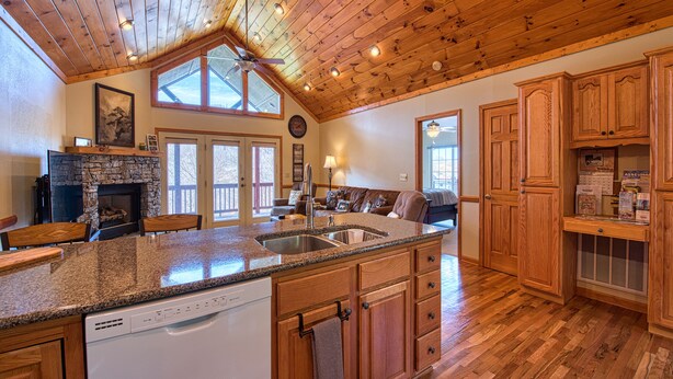 A spacious kitchen with wooden cabinets, a granite countertop, and a dishwasher. - 2 BD 2 BA Cottage, Paved Access, Close to Town, Super Views, Cable, WIFI, (Waynesville)