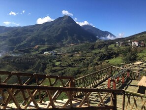Cross a wooden bridge to a serene mountain retreat.