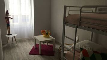 Cozy space for kids, featuring a bunk bed and a small table with a toy.