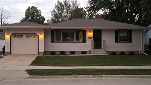 A single-story house with a garage, a front porch, and a well-maintained lawn.
