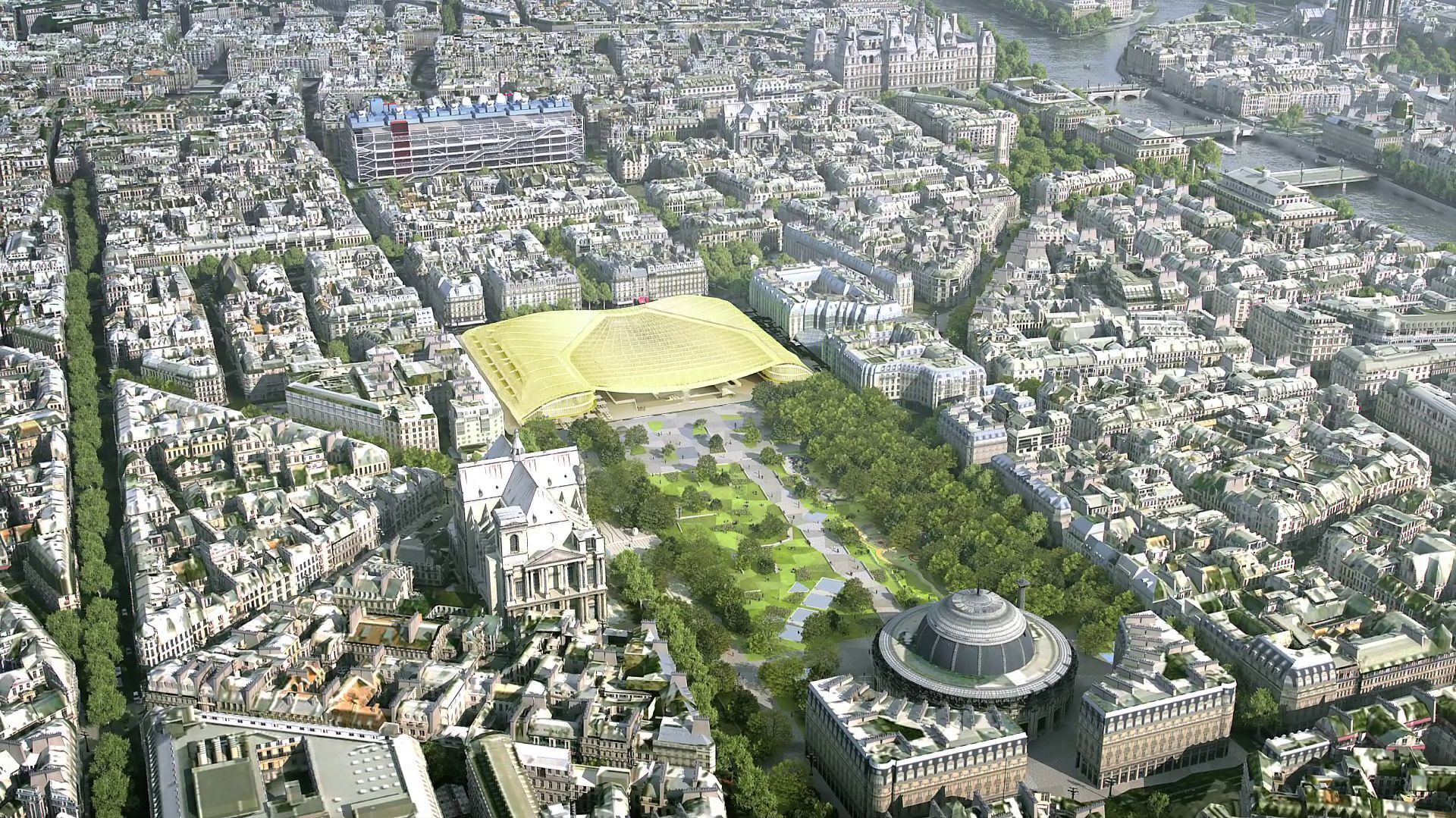 Une vue aérienne d’une ville, avec un grand stade, des bâtiments historiques et un bâtiment circulaire situé au centre.