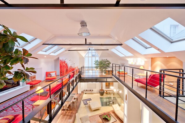 A spacious loft with high ceilings, skylights, and a mezzanine level.