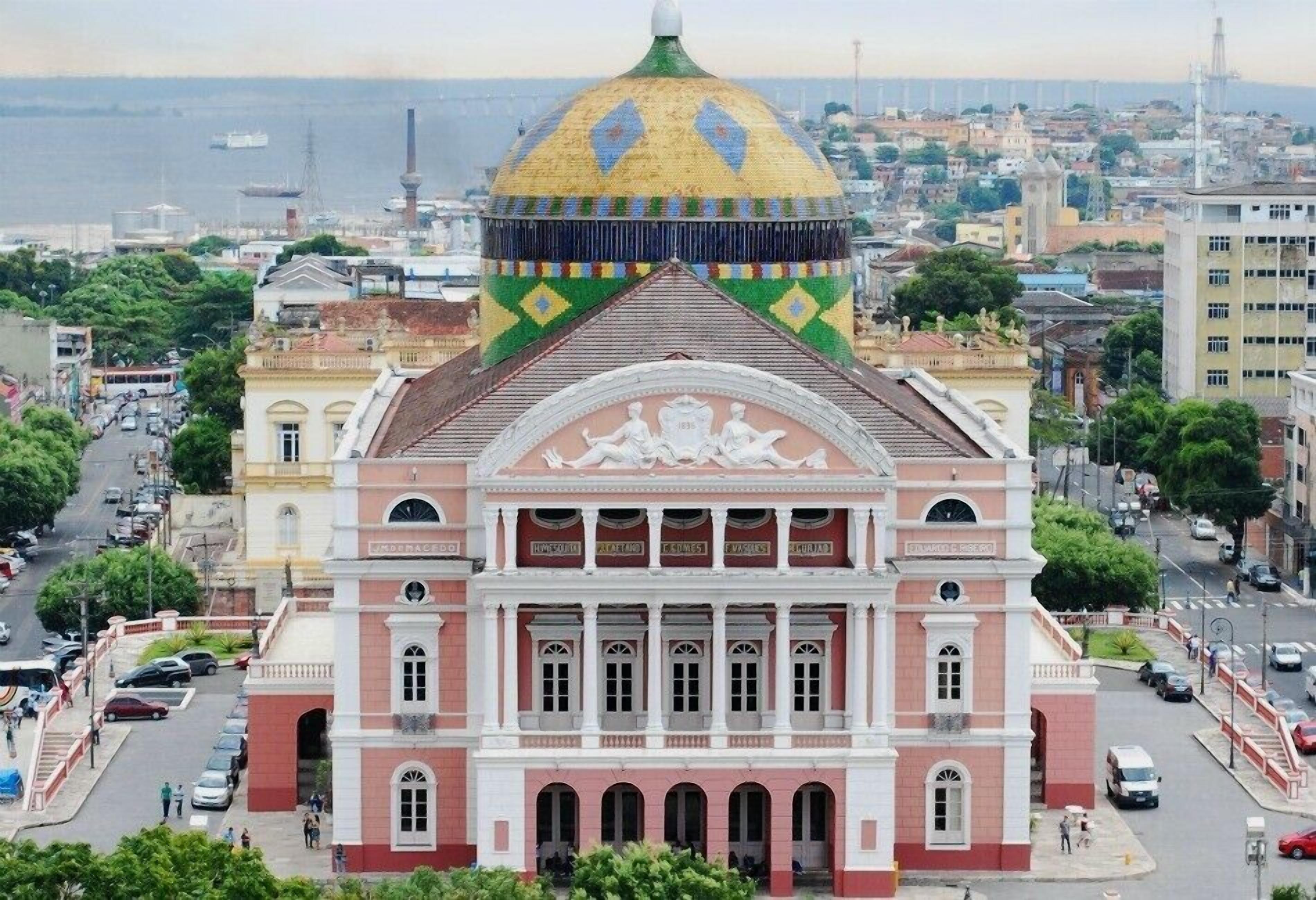 A large, historic building with a prominent dome and a central entrance with columns.