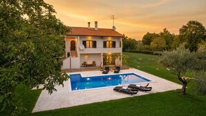 A two-story house with a swimming pool and outdoor seating area. - ***Apartment with private pool and large garden (Nova Vas)