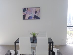 Enjoy meals in a stylish dining area with a city view.